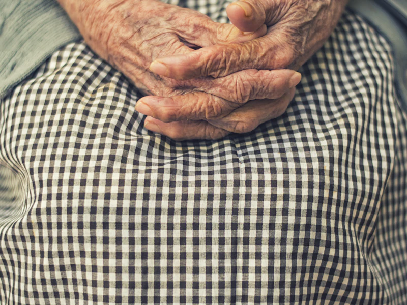 An elderly parent's folded hands