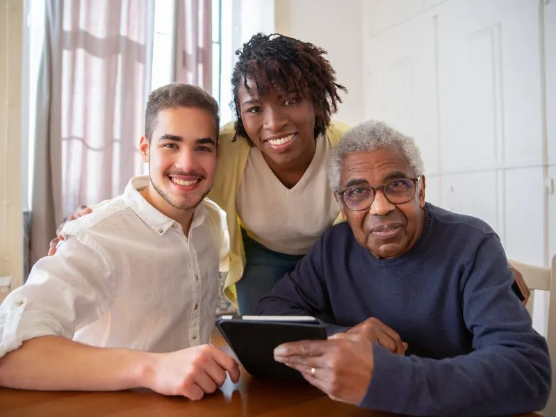A social worker reviews care options with a client and his family at home