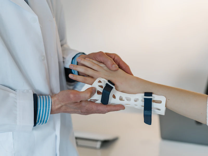 An occupational therapist fits a supportive wrist brace for a patient
